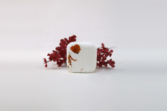 A white shower steamer with a floral pattern on the top surface, surrounded by red decorative flowers on a white background.