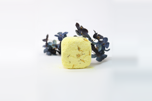 A yellow shower steamer with herbs on a white background, designed to transform the shower into a spa-like experience.