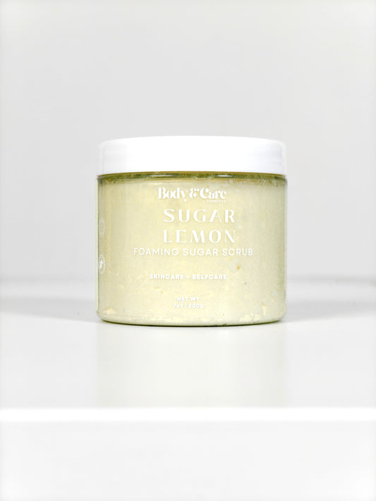 Body & Care Sugar Lemon Foaming Sugar Scrub in a clear jar with white lid on a white background.