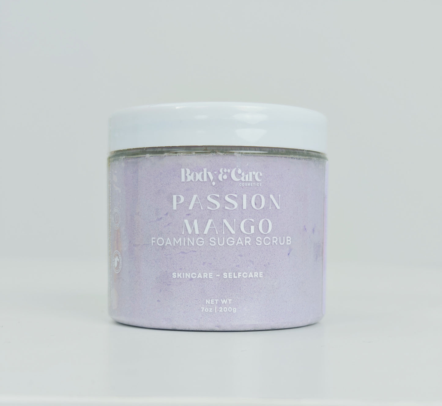 Body & Care Passion Mango Foaming Sugar Scrub photographed in a clear jar on a light background.